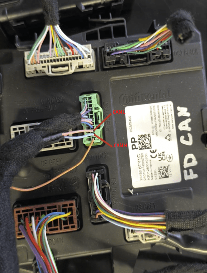A close up of a car's wiring harness with a label that reads “Can". AI generated content